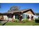 Charming single-story home boasts a manicured lawn and mature landscaping at 104 Gloucester Blvd # 340, Sun City Center, FL 33573