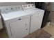 Close-up of a white Maytag washer and dryer set with black trash can at 104 Gloucester Blvd # 340, Sun City Center, FL 33573