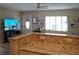 Open concept living room with granite counter top bar and a view of the front door and television at 104 Gloucester Blvd # 340, Sun City Center, FL 33573