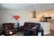 Spacious living room features leather furniture, open to the modern kitchen at 104 Gloucester Blvd # 340, Sun City Center, FL 33573