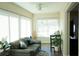 Bright living room with desk, leather couch and many windows for natural light at 104 Gloucester Blvd # 340, Sun City Center, FL 33573