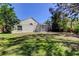 A spacious backyard with lush green grass and a screened-in pool enclosure at 10614 Chambers Dr, Tampa, FL 33626