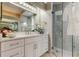 Elegant bathroom featuring a glass enclosed shower and a vanity with white cabinets and countertop at 10614 Chambers Dr, Tampa, FL 33626