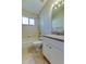 Bright bathroom featuring a shower-tub combo and a vanity with a large mirror at 10614 Chambers Dr, Tampa, FL 33626