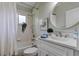 Bright bathroom featuring a shower-tub combination, white vanity, and decorative accents at 10614 Chambers Dr, Tampa, FL 33626