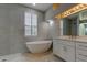 Beautiful bathroom featuring a modern tub, walk-in shower, and a double-sink vanity at 10614 Chambers Dr, Tampa, FL 33626