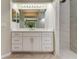 Bathroom boasts a modern vanity with double sinks, ample lighting, and a luxurious walk-in shower at 10614 Chambers Dr, Tampa, FL 33626