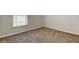 Neutral bedroom with carpet, base molding, and a window letting in natural light at 10614 Chambers Dr, Tampa, FL 33626
