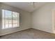 Cozy bedroom with neutral walls, carpet, and a window overlooking the yard at 10614 Chambers Dr, Tampa, FL 33626