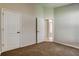 Neutral bedroom featuring carpeted floors and closet space at 10614 Chambers Dr, Tampa, FL 33626