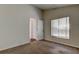 Bedroom featuring a window with blinds and a doorway leading to another room at 10614 Chambers Dr, Tampa, FL 33626