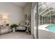 Bright sitting area featuring a chair and table with outdoor view of the pool at 10614 Chambers Dr, Tampa, FL 33626