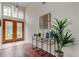 Inviting entryway with double doors, tile floors, decor, and a unique light fixture above at 10614 Chambers Dr, Tampa, FL 33626