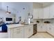 Modern kitchen featuring white cabinetry, stainless steel appliances, and a breakfast bar at 10614 Chambers Dr, Tampa, FL 33626
