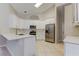 Open concept kitchen with island, stainless appliances, and white cabinets at 10614 Chambers Dr, Tampa, FL 33626
