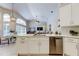 Bright kitchen featuring white cabinets, stainless steel appliances and open to the dining area at 10614 Chambers Dr, Tampa, FL 33626