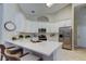 Bright kitchen boasts quartz counters, stainless steel appliances, and an island with seating at 10614 Chambers Dr, Tampa, FL 33626