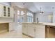 Bright kitchen with white cabinets, countertops, and stainless steel appliances at 10614 Chambers Dr, Tampa, FL 33626