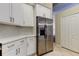 Kitchen features stainless steel appliances, white cabinets, and tile backsplash at 10614 Chambers Dr, Tampa, FL 33626