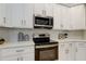 Updated kitchen with white cabinets, stainless steel microwave, and a sleek, modern design at 10614 Chambers Dr, Tampa, FL 33626