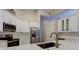 Modern kitchen featuring stainless steel appliances, white cabinets, and a stylish sink area at 10614 Chambers Dr, Tampa, FL 33626