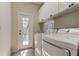 Laundry room with modern washer and dryer, and a door leading to the pool at 10614 Chambers Dr, Tampa, FL 33626