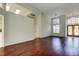 Large living room featuring hardwood floors, decorative lighting, and a decorative wooden front door at 10614 Chambers Dr, Tampa, FL 33626