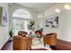 Cozy living room featuring stylish seating around a central glass coffee table and natural light at 10614 Chambers Dr, Tampa, FL 33626