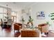 Open-concept living area with dining table and chairs, wood floors, and leather chairs at 10614 Chambers Dr, Tampa, FL 33626