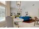 Bright living room with vaulted ceilings, modern lighting, and a cozy seating area with blue sofa at 10614 Chambers Dr, Tampa, FL 33626