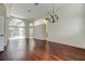 Bright, spacious living room with hardwood floors, large windows, and sliding doors to a screened-in patio at 10614 Chambers Dr, Tampa, FL 33626