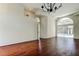 Spacious living room with high ceilings, hardwood floors, and access to the outdoor pool area through sliding doors at 10614 Chambers Dr, Tampa, FL 33626