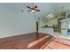 Spacious living room with hardwood floors, ceiling fan, and plenty of natural light at 10614 Chambers Dr, Tampa, FL 33626