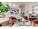 Open-concept living area with wood floors, leather chairs, modern art, and a seamless flow at 10614 Chambers Dr, Tampa, FL 33626