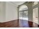 Bright living area with hardwood floors and sliding doors to the screened-in patio and outdoor pool at 10614 Chambers Dr, Tampa, FL 33626