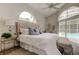 Tranquil main bedroom with large windows, neutral decor, and an outside view of the pool at 10614 Chambers Dr, Tampa, FL 33626