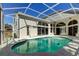 Screened-in backyard pool with tiled deck and views of the home's back windows at 10614 Chambers Dr, Tampa, FL 33626