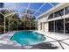 Outdoor pool area with a screened enclosure and various views of the home's architecture at 10614 Chambers Dr, Tampa, FL 33626