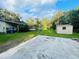 Backyard featuring a shed and partial view of the deck; spacious area with lush green grass at 11045 Scott Loop, Riverview, FL 33569