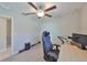 Bedroom featuring a ceiling fan and light fixture, plush carpet, desk and a gray gaming chair at 11323 Misty Moss Dr, Wimauma, FL 33598