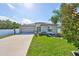 Charming single-story home boasts a well-manicured lawn and inviting curb appeal on a sunny day at 11323 Misty Moss Dr, Wimauma, FL 33598