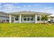 Spacious backyard featuring green grass and a covered patio at 11885 Richmond Trl, Parrish, FL 34219