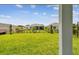 View of the backyard showcasing lush green grass and secure fencing at 11885 Richmond Trl, Parrish, FL 34219