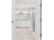 Modern bathroom showcasing white cabinetry, a tiled shower with glass partition, and contemporary finishes at 11885 Richmond Trl, Parrish, FL 34219