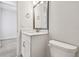 Compact bathroom featuring a modern vanity, toilet, and sleek design, optimizing space and functionality at 11885 Richmond Trl, Parrish, FL 34219
