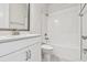 Clean, modern bathroom with sleek white vanity, tiled shower, and contemporary fixtures at 11885 Richmond Trl, Parrish, FL 34219