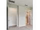 Bright bedroom with a closet and bathroom entrance featuring neutral walls, carpet floors, and modern fixtures at 11885 Richmond Trl, Parrish, FL 34219