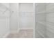 Walk-in closet offering adjustable wire shelving, carpet floors, and ample storage space for organization at 11885 Richmond Trl, Parrish, FL 34219