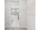 View of walk-in closet with wire shelving looking into bathroom with glass enclosed shower at 11885 Richmond Trl, Parrish, FL 34219
