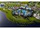 Aerial view of a resort-style community pool, a playground, and beautiful landscaping at 11885 Richmond Trl, Parrish, FL 34219